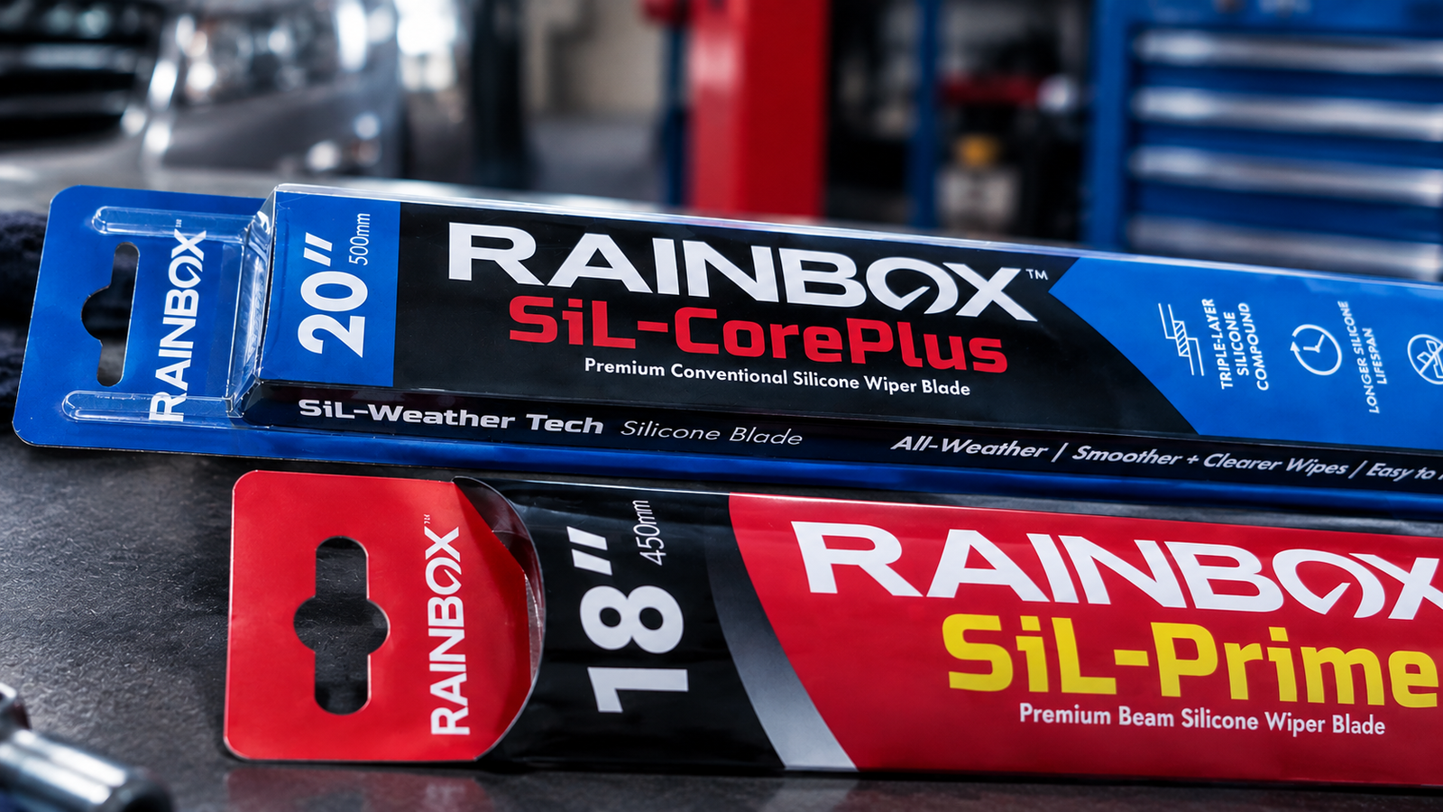 Rainbox SiL-CorePlus 20-inch and SiL-Prime 18-inch packages photographed on an automotive workshop bench